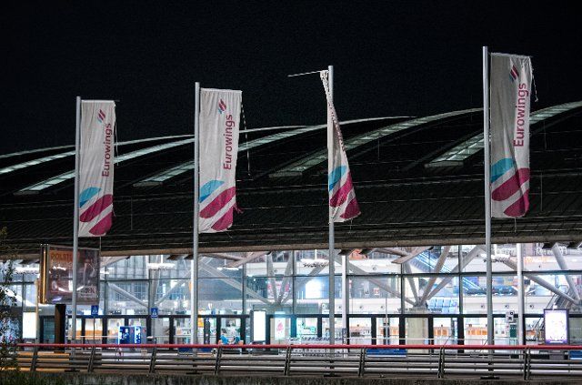 06 October 2022, Hamburg: Flags of the airline Eurowings fly at the airport in front of the terminal. Pilots of the airline Eurowings went on a day-long strike today. (to dpa "Pilots\