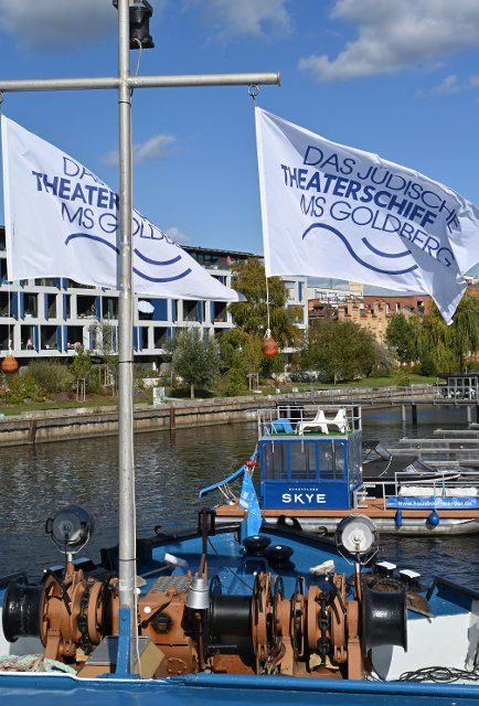 06 October 2022, Brandenburg, Potsdam: Flags fly in the marina on the Jewish Culture and Theater Ship MS Goldberg. After various stops in Berlin, the "Goldberg" will move across Berlin\
