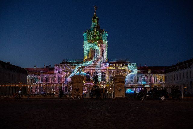 06 October 2022, Berlin: Charlottenburg Palace is illuminated during the Festival of Lights rehearsal. Photo: Paul Zinken\/dpa