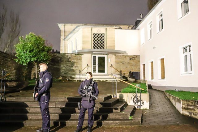 30 November 2022, North Rhine-Westphalia, Hagen: Two officers stand in front of the synagogue in the city center. Almost two weeks after the shooting at the rabbi\