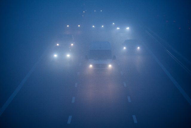 01 December 2022, Saxony, Schkeuditz: Cars and trucks drive across the A14 freeway in fog and poor visibility. Photo: Jan Woitas\/dpa