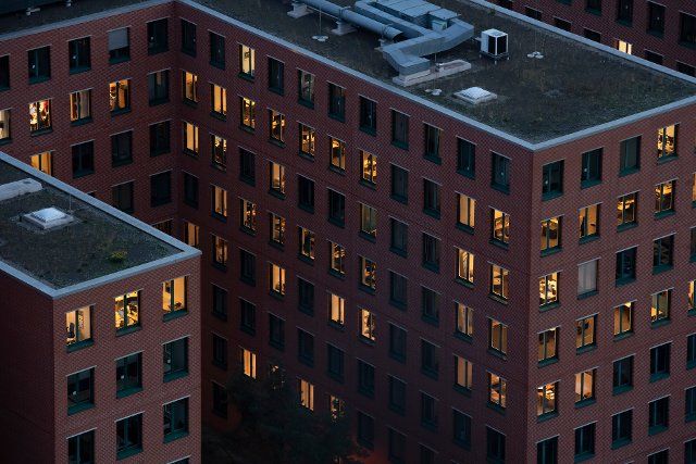 08 November 2022, Berlin: In an office building, numerous offices are lit up. Photo: Paul Zinken\/dpa