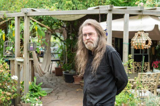 09 August 2018, Germany, Neuss: The bestselling author Wolfgang Hohlbein standing in his garden. He turns 65 on August 15. Photo: Christophe Gateau\/