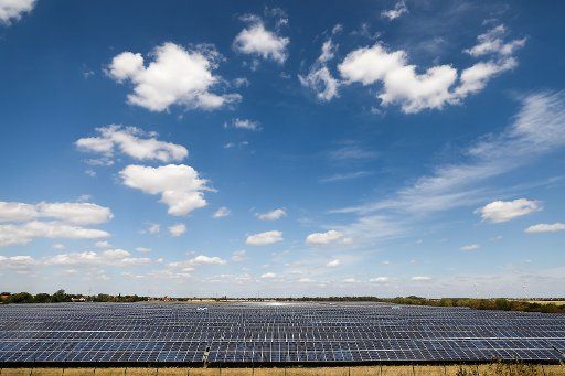 10 August 2018, Germany, Bitterfeld-Wolfen: Clouds move above a solar park at nice weather. Photo: Jan Woitas\/dpa-Zentralbild\/