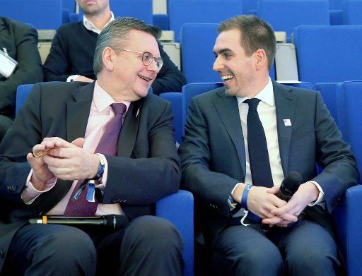 FILED - 30 January 2018, Germany, Duesseldorf: Reinhard Grindel (l), President of the German Football Association (DFB), and former German football player Philipp Lahm chat at the SpoBis sports business congress. Photo: Roland Weihrauch\/