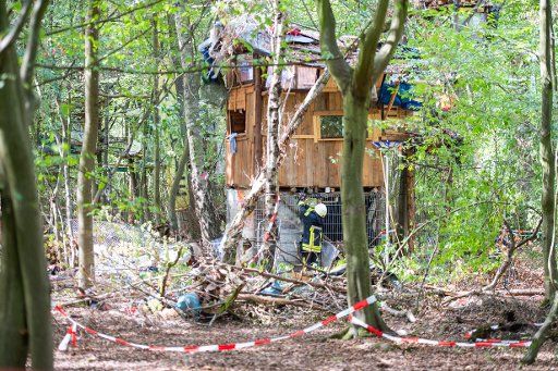 15 September 2018, North Rhine-Westphalia, Kerpen: A fireman is on duty at a hut in the Hambach Forest. At least one person is said to have been entrenched in the hut for more than 24 hours. The clearance in the Hambach Forest will continue. Photo: Christophe Gateau\/