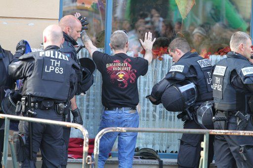 06 October 2018, Thuringia, Apolda: 06 October 2018, Germany, Apolda: A visitor is checked by the police before a right-wing rock concert begins. (to dpa "Hick-Hack um Ort für Rechtsrock-Konzert - Protests in Apolda " from 06.10.2018) Photo: Sebastian Haak\/dpa-Zentralbild\/
