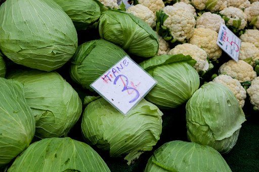 11 December 2018, Turkey, Tire: Cabbage is offered on the market by a trader at a market stall. An overprinted price tag shows a reduced price from four to three Turkish liras. Photo: Jens Kalaene\/dpa-Zentralbild\/