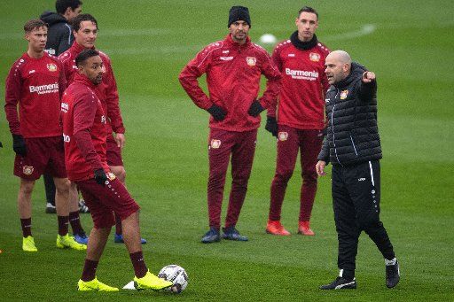 04 January 2019, North Rhine-Westphalia, Leverkusen: Peter Bosz (r), new coach of Bundesliga soccer team Bayer Leverkusen, explains an exercise during his first training session with the team Karim Bellarabi. Photo: Marius Becker\/dpa - IMPORTANT NOTE: In accordance with the requirements of the DFL Deutsche Fußball Liga or the DFB Deutscher Fußball-Bund, it is prohibited to use or have used photographs taken in the stadium and\/or the match in the form of sequence images and\/or video-like photo sequences.