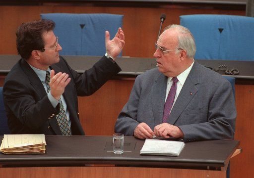 FILED - 25 April 1996, North Rhine-Westphalia, Bonn: During the debate on the tenth anniversary of the Chernobyl disaster in the Bundestag, the former Foreign Minister Klaus Kinkel (l, FDP) and the former Chancellor Helmut Kohl (CDU) talked gesture-rich. (to dpa "Former German Foreign Minister Kinkel Died") Photo: Tim Brakemeier\/