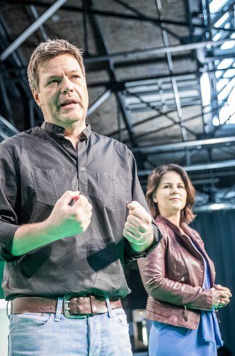 29 March 2019, Berlin: Robert Habeck, Federal Chairman of Bündnis90\/Die Grünen, speaks alongside Annalena Baerbock, Co-Bundesvorsitzende von Bündnis90\/Die Grünen, at the start of the "fundamental convention" of the Greens. In autumn 2020, 40 years after the founding of the party, the Greens want to give themselves a new basic programme. At the convention, 800 to 1000 participants will discuss the interim status. Photo: Michael Kappeler\/
