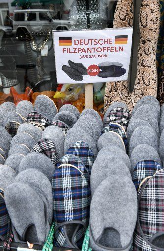 11 April 2019, Berlin: A shop in Eberswalder Straße advertises with "German slippers from Saxony". Photo: Jens Kalaene\/dpa-Zentralbild\/