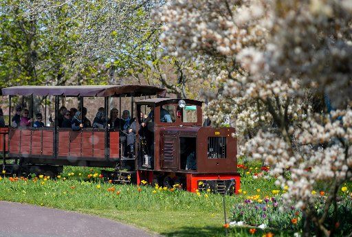 18 April 2019, Berlin: The park railway travels through the Britzer Garten in sunny weather. Photo: Monika Skolimowska\/dpa-Zentralbild\/