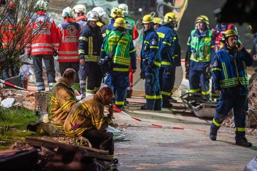 20 May 2019, Bavaria, Rettenbach Am Auerberg: Firefighters take a break at the edge of a house destroyed by an explosion. Photo: Lino Mirgeler\/