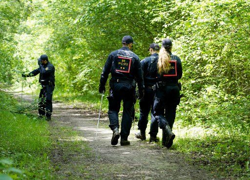28 May 2019, Baden-Wuerttemberg, Rust: Policemen search the surroundings of the site where a woman\