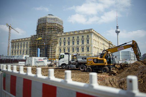 12 June 2019, Berlin: Construction machines are located opposite the Humboldt-Forum construction site in the new Berlin City Palace. The Berlin television tower can be seen in the background. Photo: Gregor Fischer\/