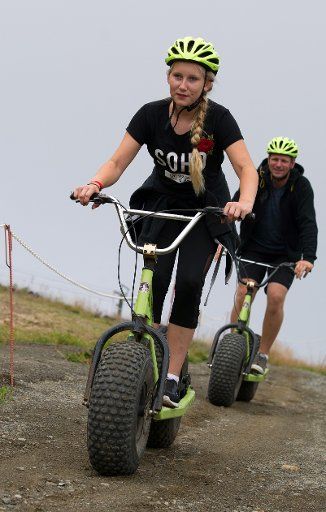 Celine and Tristan from Schwerin riding on monster scooters on Wurmberg mountain near Braunlage, Germany, 16 August 2017. Photo: Swen Pförtner\/