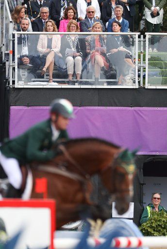 Queen Silvia of Sweden and Carl XVI Gustaf (C, top) of Sweden sit on the stands during the single show jumping competition of the FEI European Championships 2017 in Gothenburg, Sweden, 27 August 2017. Photo: Friso Gentsch\/