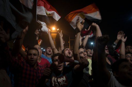 Egyptians wave national flags as they gather at Tahrir square to celebrate their national football team qualification for the FIFA 2018 World Cup for the first time in 28 years after beating the Republic of Congo 2-0 during their FIFA 2018 World ...