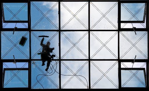 Glass and buildings cleaner Andreas Reimann cleaning the glass panes of the roof of the "World Trade Center" in Dresden, Germany, 9 October 2017. Photo: Monika Skolimowska\/dpa-Zentralbild\/