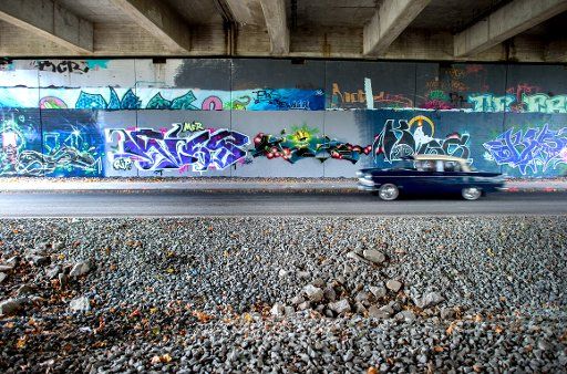 A car drives below the so-called graffiti bridge (\
