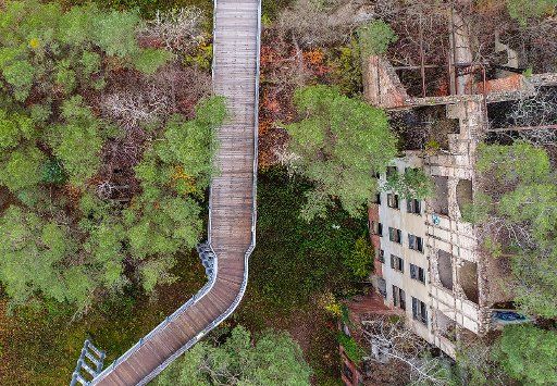 The canopy walkway leads above trees and the ruins of a former sanatorium for consumptives on the premises of the former Beelitz sanatorium in Beelitz, Germany, 20 November 2017. The 320 metre long walkway was opened in September 2015, leading ...