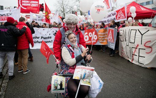 Two employees dressed as old people demonstrate in Luebeck, Germany, 8 December 2017. The demonstration is before the beginning of the second round of wage negotiations for the metal and electrical industry. Photo: Daniel Reinhardt\/