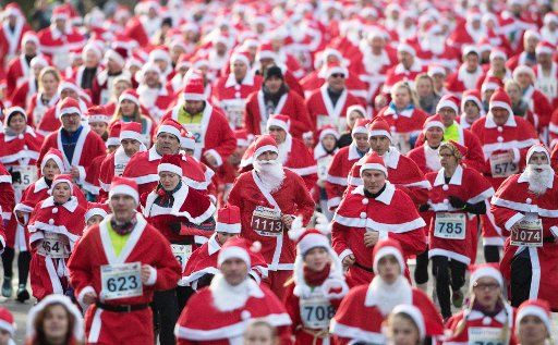 Runners in Santa Claus costumes pictured running during the traditional St Nicholas Run in Michendorf, Germany, 10 December 2017. The wearing of Santa Claus costumes is a requrement during the race in Brandenburg\