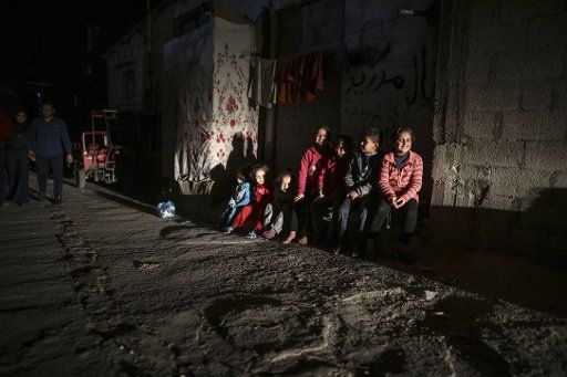 Palestinian children play in a dark street during apower outage in Al Shateaa refugee camp in Rafah, southern Gaza Strip, 15 February 2018. Photo: Wissam Nassar\/