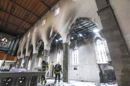 10 March 2018, Germany, Ravensburg: Firefighters inspect the damages in the church of St. Jodok after a fire. Photo: Felix Kästle\/
