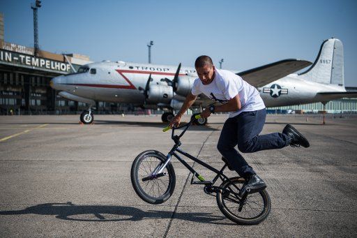 10 April 2018, Berlin, Germany: Camilo Gutierrez, a professional BMX biker showing off his tricks on the bike. The bicycle festival "VeloBerlin" will take place from on the 14th and 15th of May, at airdock 5 of Tempelhof airport. Photo: Arne Bänsch\/