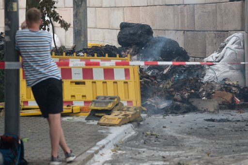 24 May 2018, Germany, Dresden: A man takes a photograph at the location where a WWII bomb was found. The bomb has now been made safe. Photo: Sebastian Kahnert\/dpa-Zentralbild\/