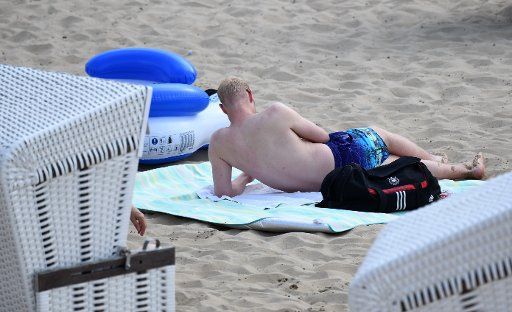 31 May 2018, Germany, Berlin: A visitor sunbathing at the Strandbad Wannsee lido in temperatures over 30 degrees centigrade. Photo: Ralf Hirschberger\/