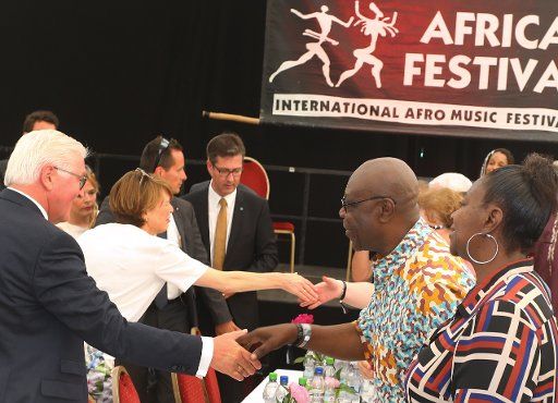 31 May 2018, Germany, Wuerzburg: German President Frank Walter Steinmeier (l) greets musician Manu Dibango at the opening of the Africa Festival. Photo: Karl-Josef Hildenbrand\/