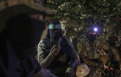 A member of Izz ad-Din al-Qassam Brigades, the military wing of the Islamist Palestinian Hamas organization, recites verses from the Qur\