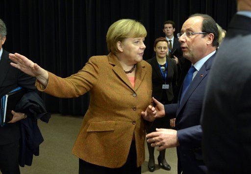 German Chancellor Angela Merkel and French President Francois Hollande talk after the group photo at the EU summit in Vilnius, Lithuania, 29 November 2013. The European Union will discuss an expansion of the partnership eastwards during the two-day ...