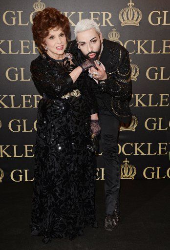 German fashion designer Harald Gloeoeckler and Italian actress Gina Lollobrigida pose in a gallery in downtown Berlin, Germany, 04 February 2014. Gloeoeckler invited Lollobrigida for a reception held on occasion of their 20 years lasting friendship. ...