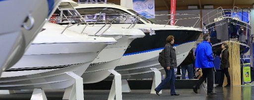 Visitors view motorboats at the Water sports fair \