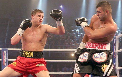 The German Tyron Zeuge (L) wins the title of the WBO Youth championship of the super middleweight boxing bout against the Romanian Gheorghe Sabau in Rostock, Germany, 05 April 2014. Ouerghi wins the fight with 12 points. Photo: Bernd Wuestneck\/