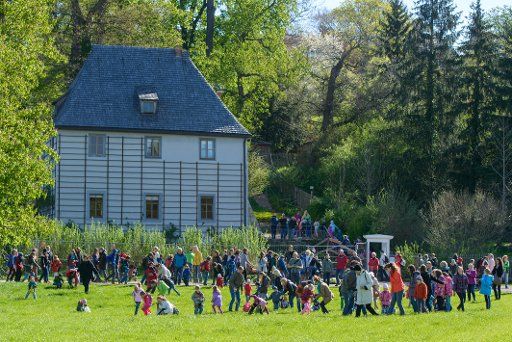 Children and adults hunt for eggs at Goethe\