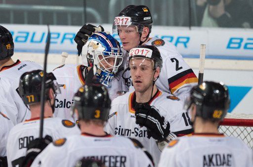 The German national ice hockey team celebrate their victory of the international ice hockey match between Germany and Switzerland at SAP-Arena in Mannheim, Germany, 02 May 2014. Photo: Uwe Anspach\/