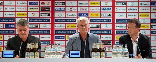New head coach of Bundesliga soccer club VfB Stuttgart Armin Veh (C) sits next to the club\