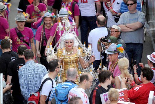 Colourful costumed participants pose during the Christopher Street Day in Cologne, Germany, 06 July 2014. Photo: Henning Kaiser\/