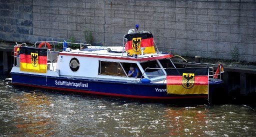 A police boat awaits the arrival of team Germany in Berlin, Germany, 15 July 2014. After 1954, 1974 and 1990, Germany defeated Argentina to become world champion for the fourth time. Photo: OLE SPATA\/