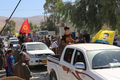 A funeral procession for a PKK fighter who died in combat with the Islamic State (IS) terror militia is seen in a village in Iraq, 12 September 2014. Photo: Thomas Rassloff\/