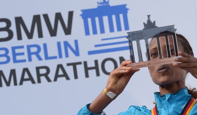Winner Tirfi Tsegaye from Ethiopia celebrates her victory at the 41st Berlin Marathon in Berlin, Germany, 28 September 2014. Around 40,000 runners participated in the 41st Berlin Marathon, which started and ended at Brandenburg Gate. PHOTO: RAINER ...