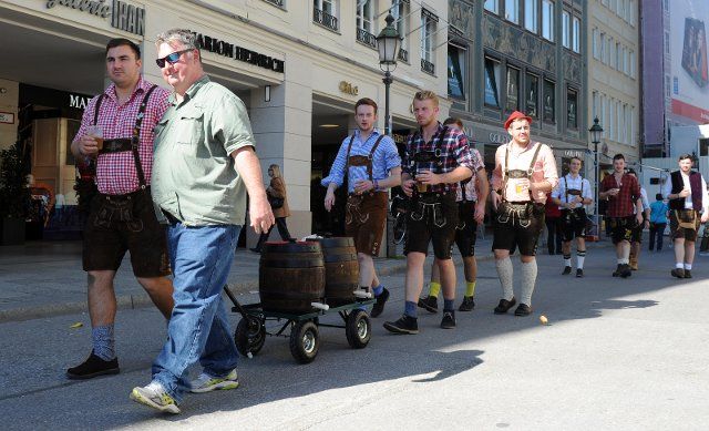 A group of men from Great Britain walk through the city with a trolly with two cases of beer before their visit of the Oktoberfest in Munich, Germany, 29 September 2014. Photo: TOBIAS HASE\/