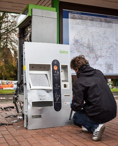 Crime scene technicians examine a blown up ticket vending machine at a tram station in Sarstedt, Germany, 09 December 2014. Again strangers blew up a ticket vending machine in the German state of Lower Saxony. Photo: Ole Spata\/