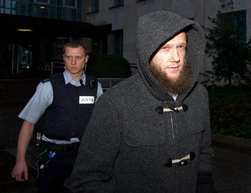 Accompanied by police the salafist preacher Sven Lau exits the District Court in Stuttgart, Germany, 17 December 2014. Lau was summoned as witness for the trial against three suspects in suspicion of membership and support of a terrorist group. Lau ...