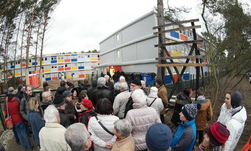 People come to visit the living container village for refugees during an Open Door Day in the district of Koepenick in Berlin, Germany, 02 February 2015. Photo: JOERG CARSTENSEN\/